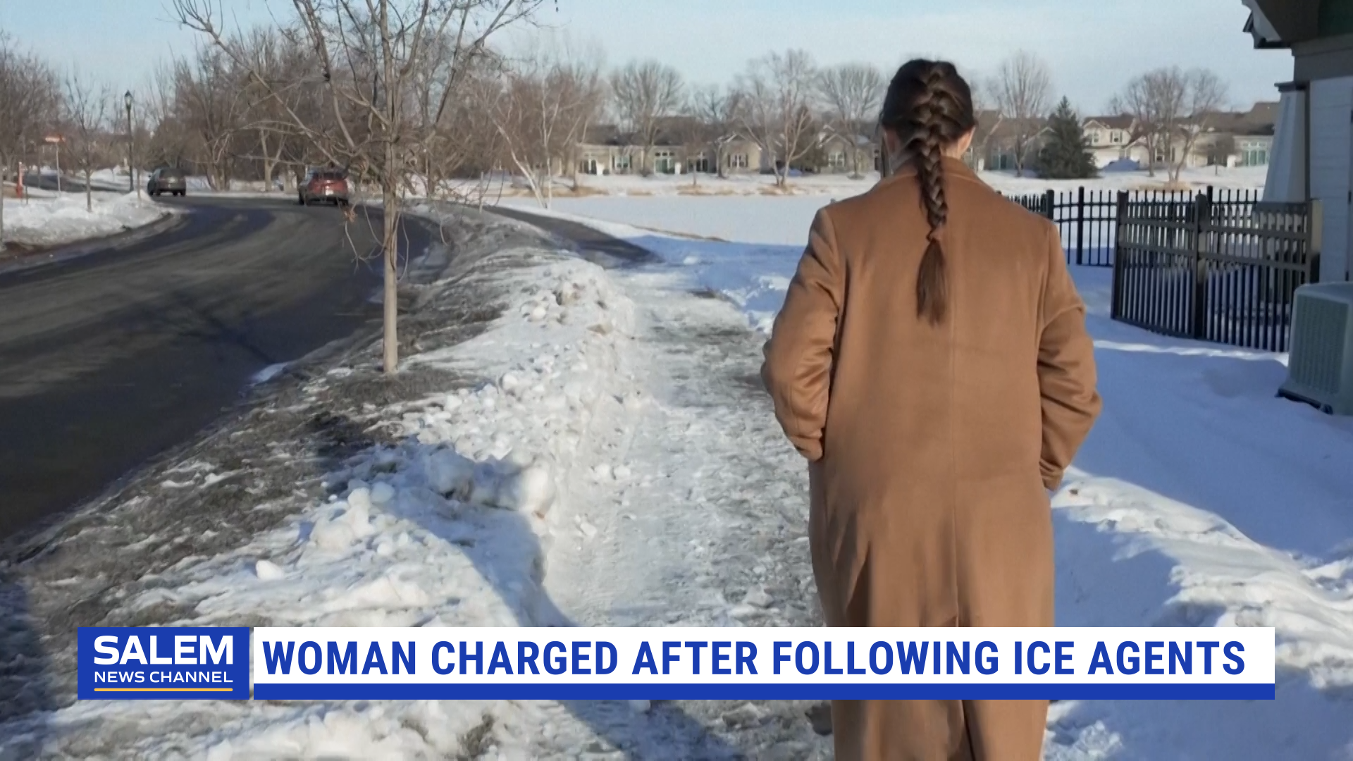 Woman charged after following ICE agents